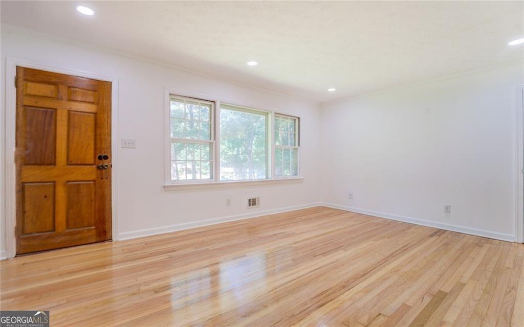 1288 Elva Drive Southwest Atlanta, GA 30331 - Photo 4 of 13 an empty room with wooden floor and windows