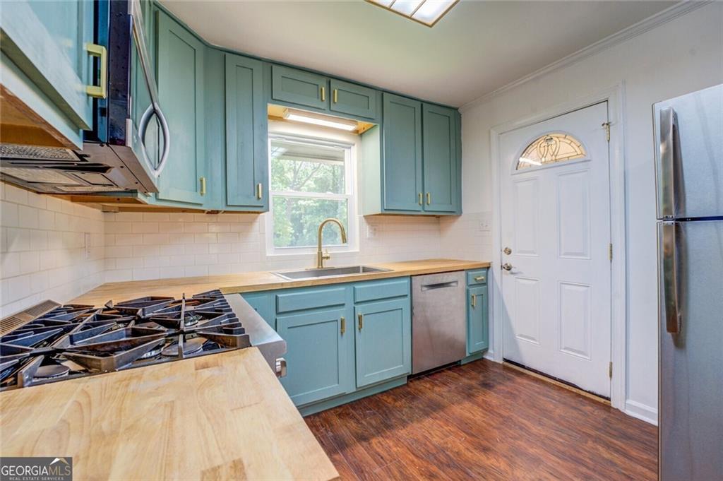 1288 Elva Drive Southwest Atlanta, GA 30331 - Photo 6 of 13 a kitchen with granite countertop a stove and a sink