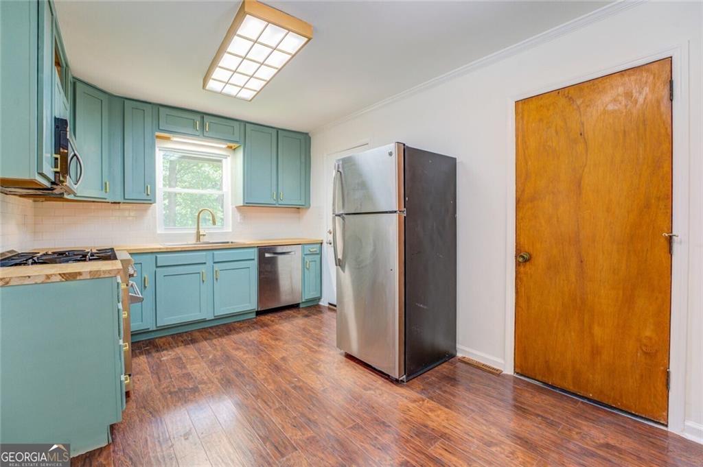 1288 Elva Drive Southwest Atlanta, GA 30331 - Photo 7 of 13 a kitchen with a refrigerator and a sink