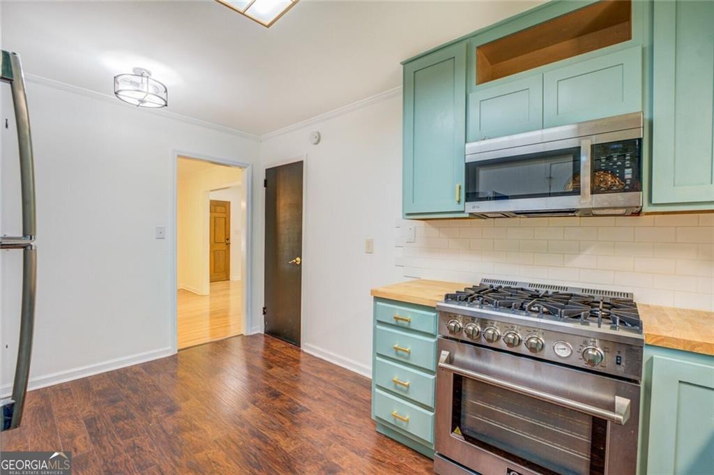 1288 Elva Drive Southwest Atlanta, GA 30331 - Photo 8 of 13 a kitchen with a stove and a microwave