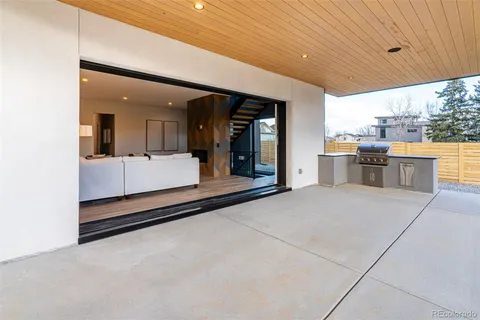 a large room with kitchen island a sink a counter space and stainless steel appliances