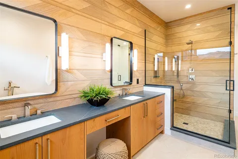 a spacious bathroom with a granite countertop sink and a large mirror
