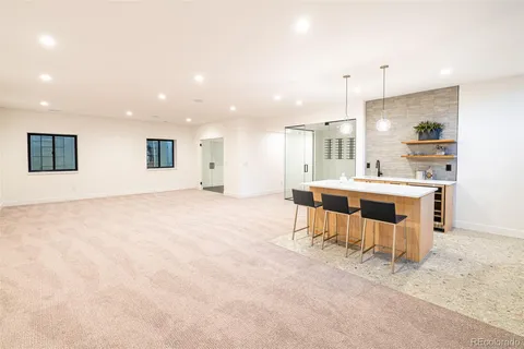 a large white kitchen with a large window