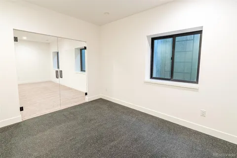 an empty room with windows and closet