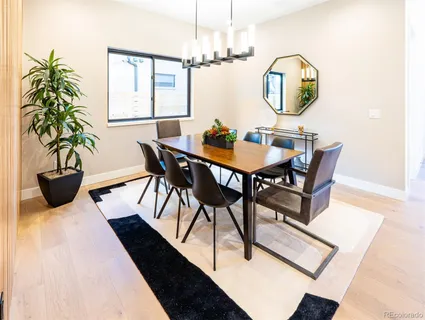 a view of a dining room with furniture and a potted plant