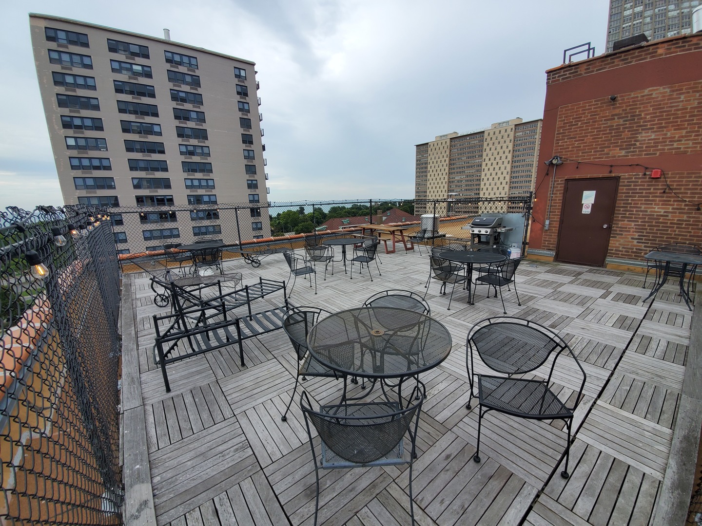 700 West Bittersweet Place, Unit 309 Chicago, IL 60613 - Photo 17 of 19 a view of a balcony with chairs and wooden floor