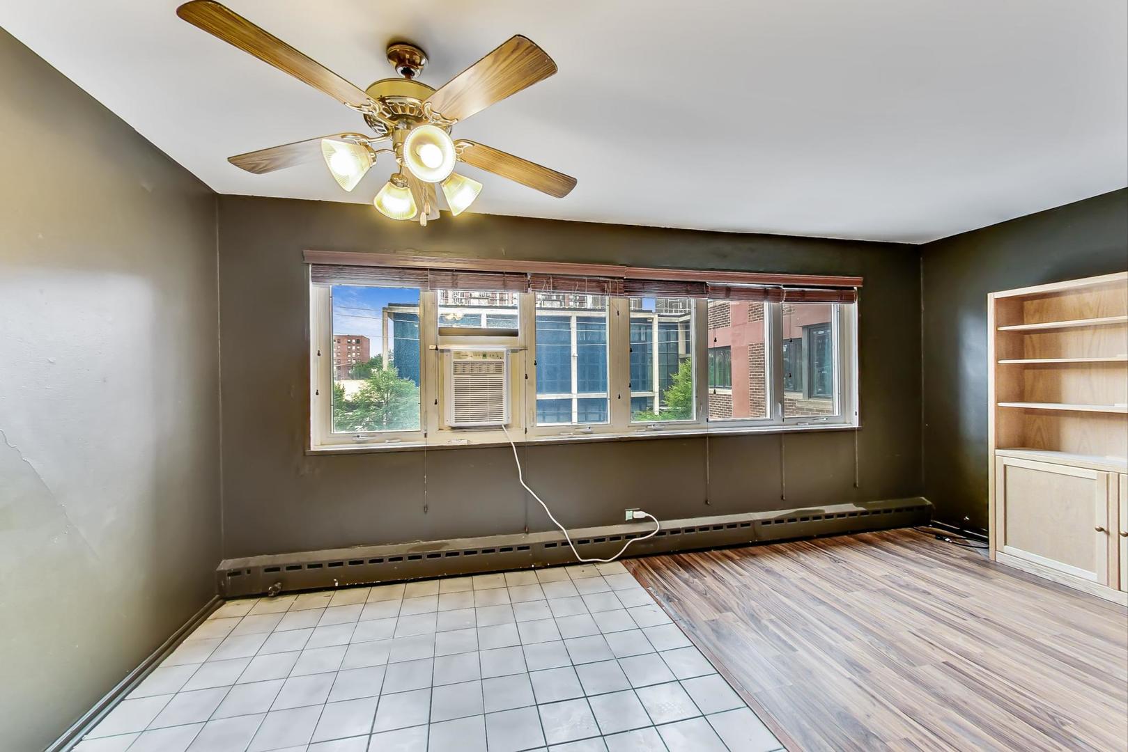 700 West Bittersweet Place, Unit 309 Chicago, IL 60613 - Photo 7 of 19 a view of an empty room with a window
