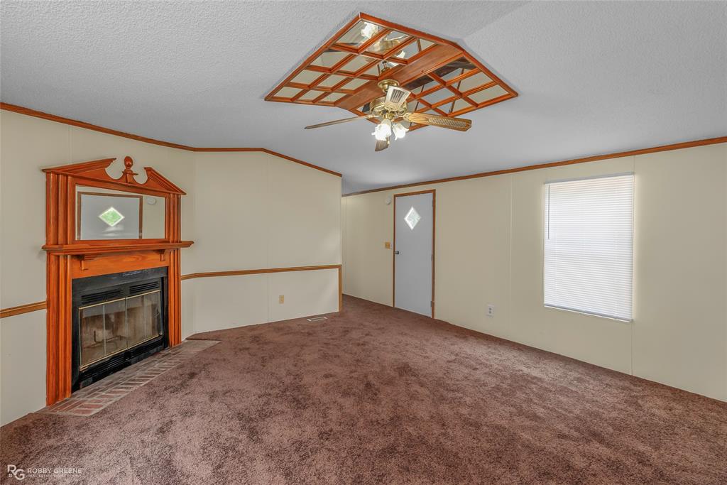 214 Springs Road Frierson, LA 71027 - Photo 6 of 21 an empty room with windows and fireplace