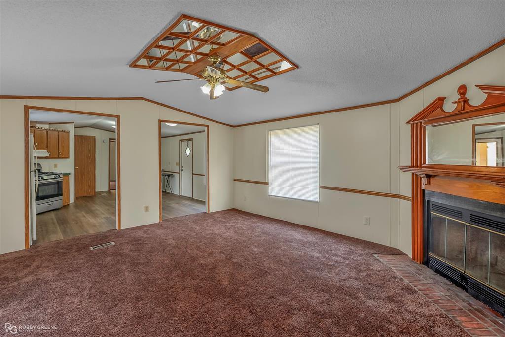 214 Springs Road Frierson, LA 71027 - Photo 7 of 21 an empty room with windows and fireplace