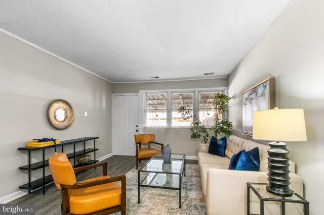 a living room with furniture a window and a clock
