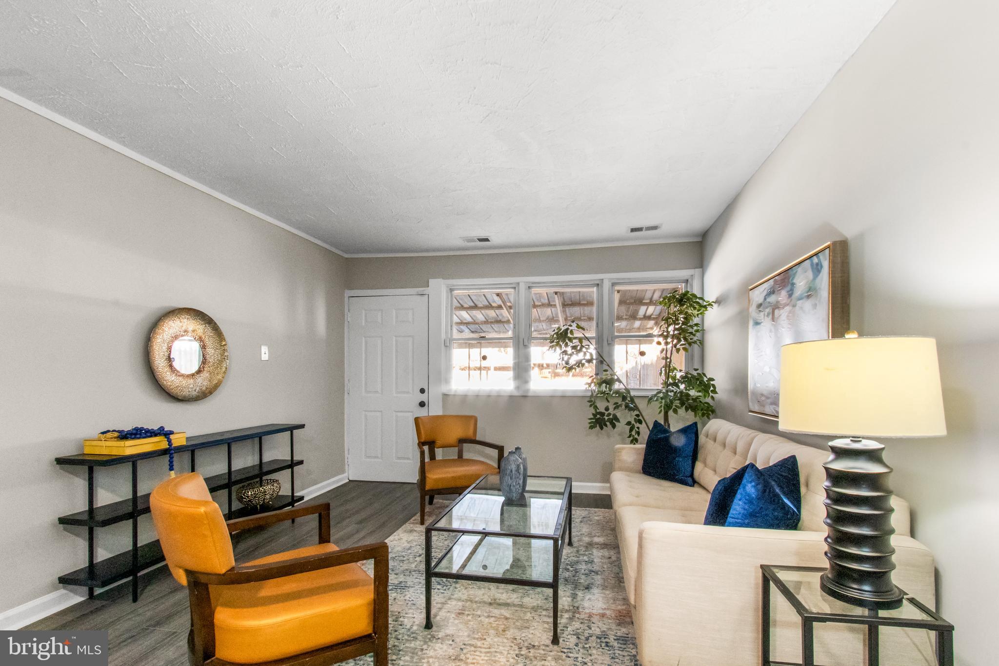 7736 Oxman Road Landover, MD 20785 - Photo 1 of 30 a living room with furniture a window and a clock