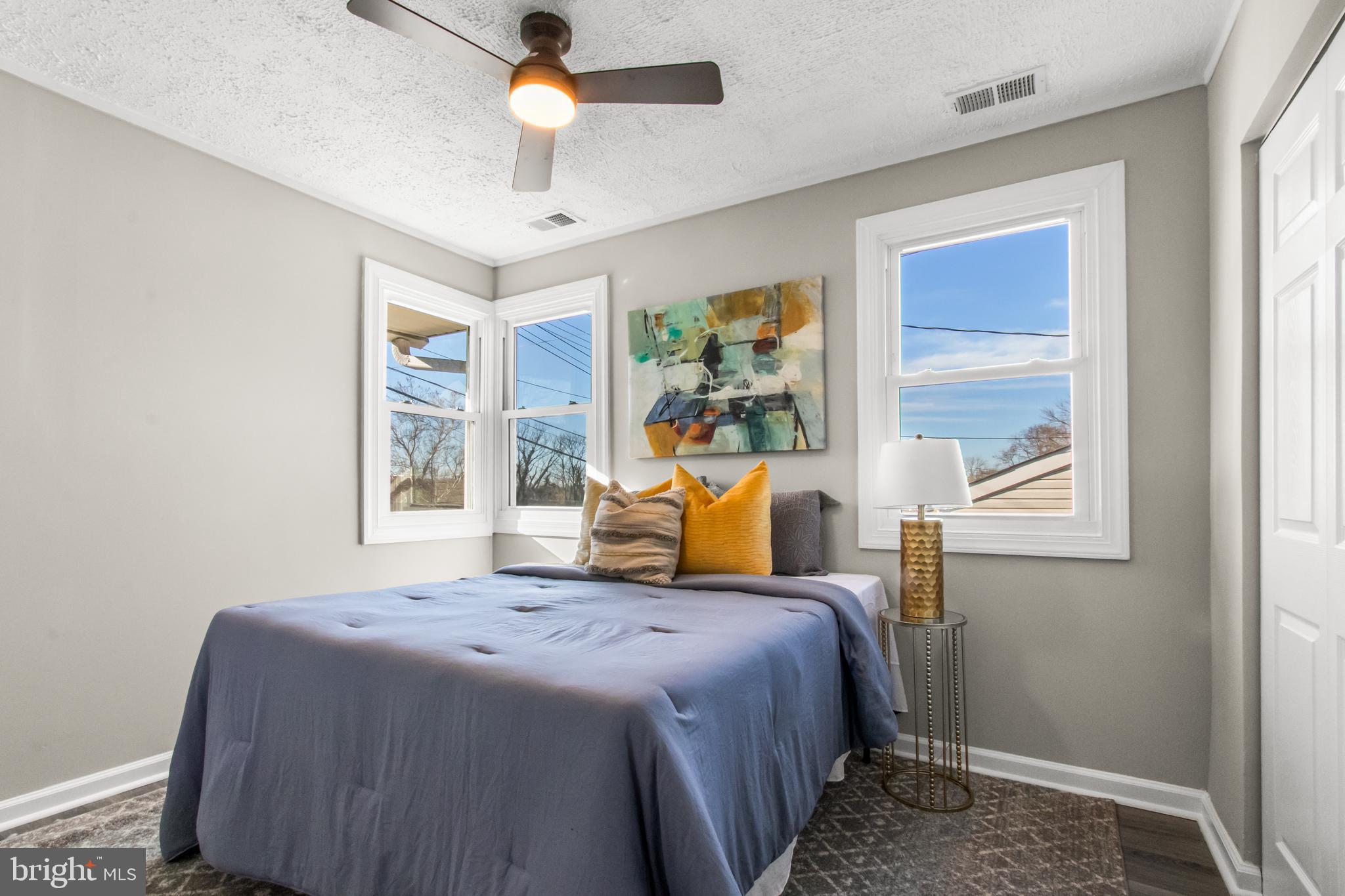 7736 Oxman Road Landover, MD 20785 - Photo 18 of 30 a bedroom with a bed and wooden floor