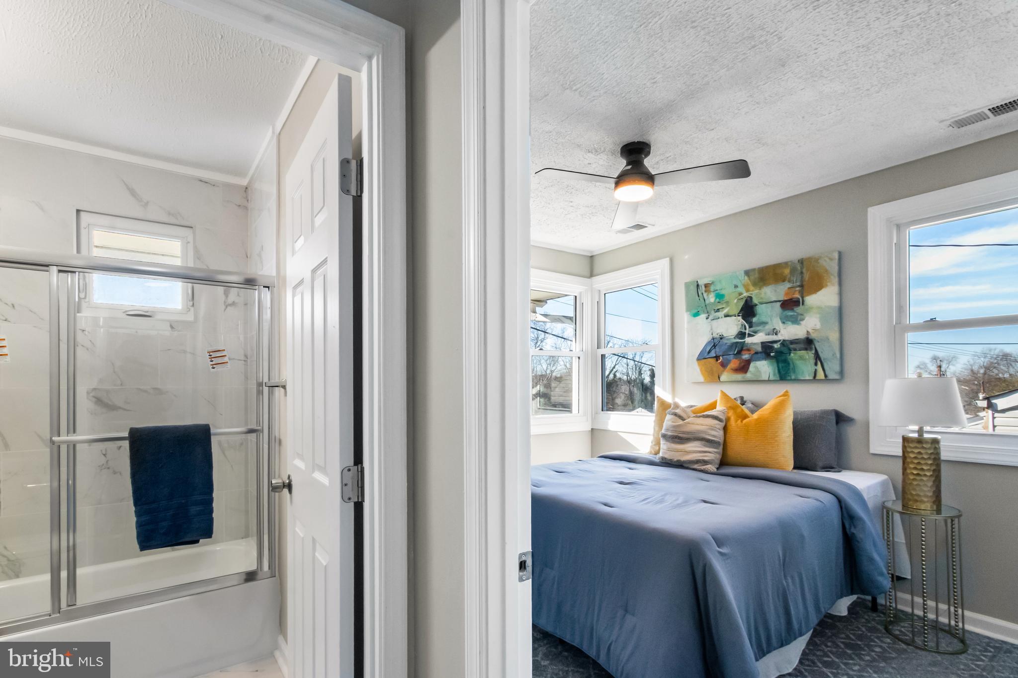 7736 Oxman Road Landover, MD 20785 - Photo 22 of 30 a bedroom with a bed a table and flat screen tv
