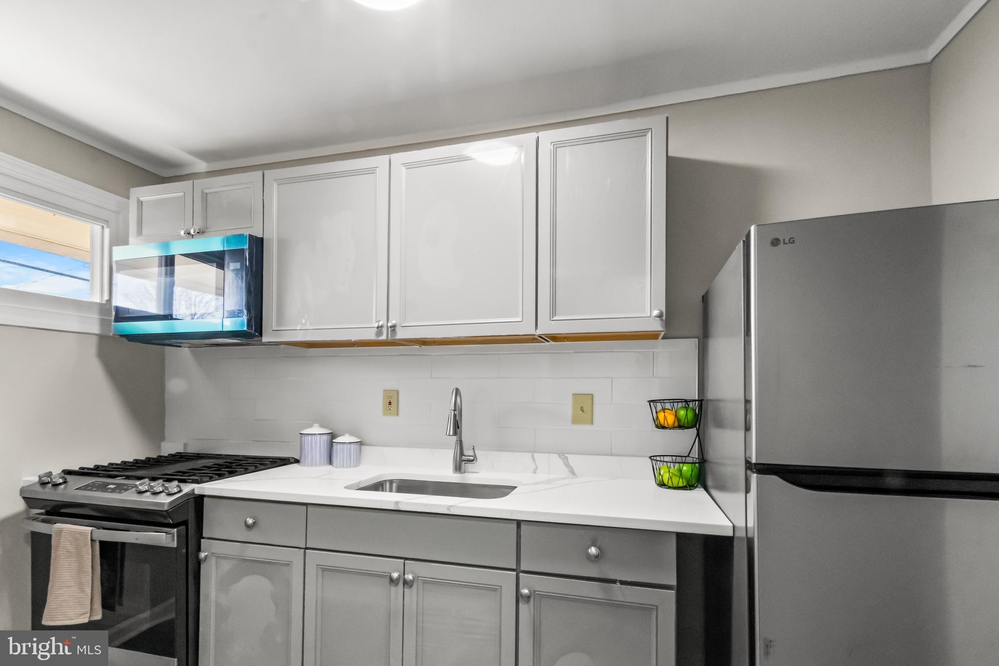 7736 Oxman Road Landover, MD 20785 - Photo 3 of 30 a kitchen with stainless steel appliances granite countertop a sink stove and refrigerator