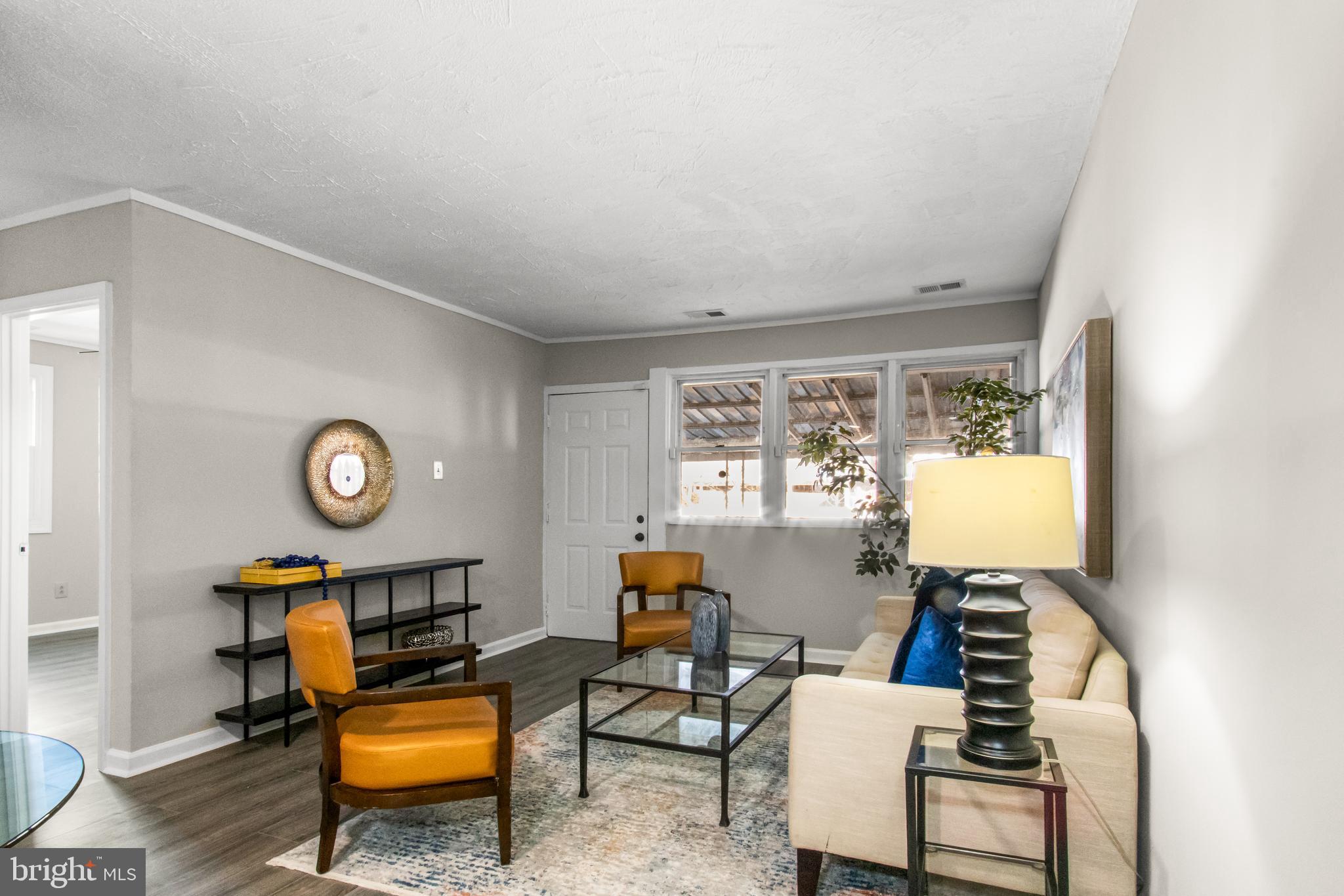 7736 Oxman Road Landover, MD 20785 - Photo 6 of 30 a living room with furniture and a lamp