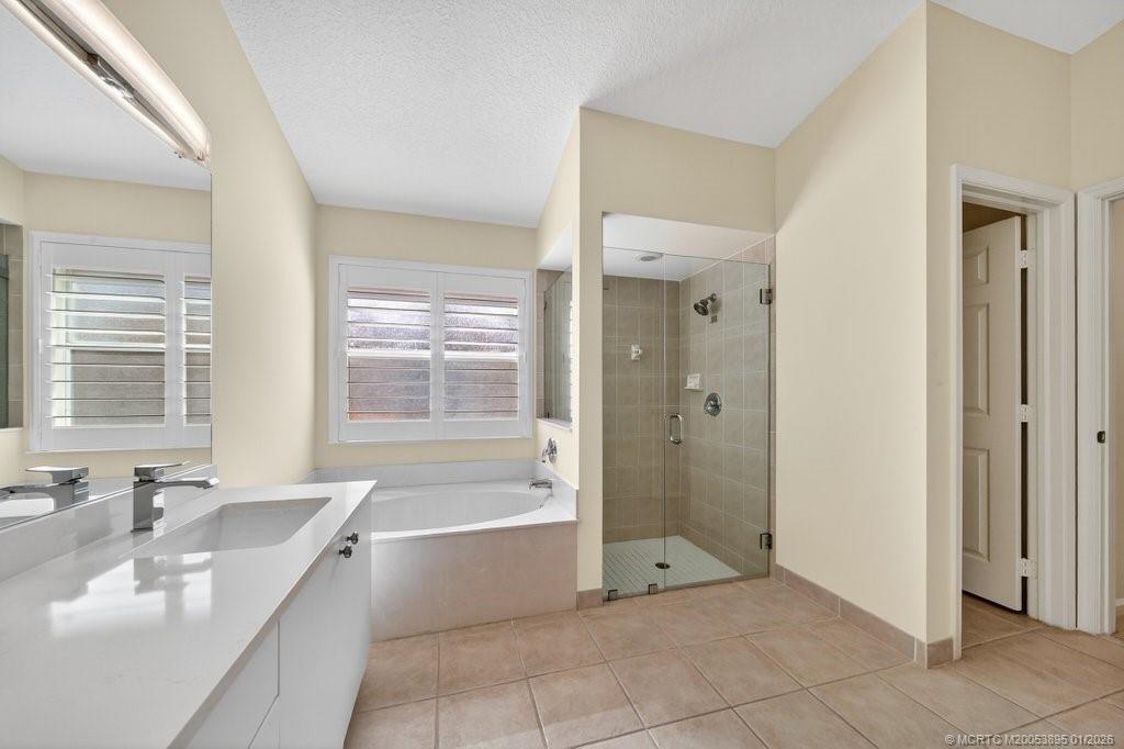 871 Southeast Westminster Place Stuart, FL 34997 - Photo 22 of 38 Primary Bathroom with tub & separate shower