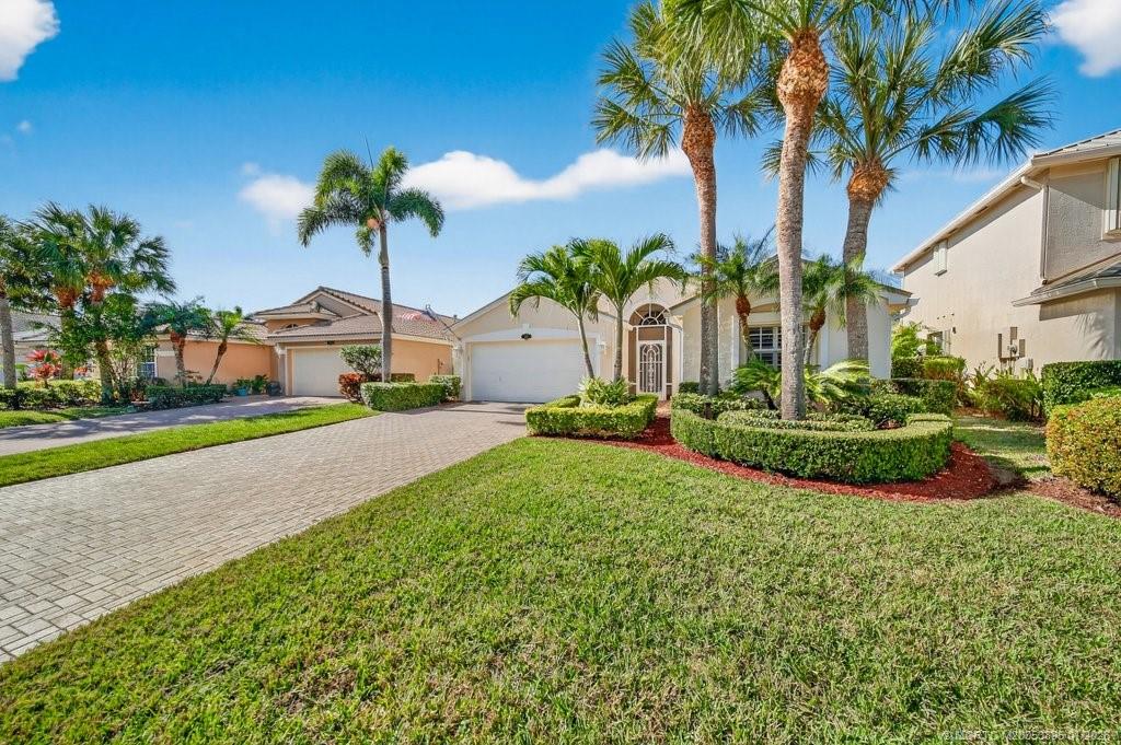 871 Southeast Westminster Place Stuart, FL 34997 - Photo 4 of 38 a view of a garden with a house