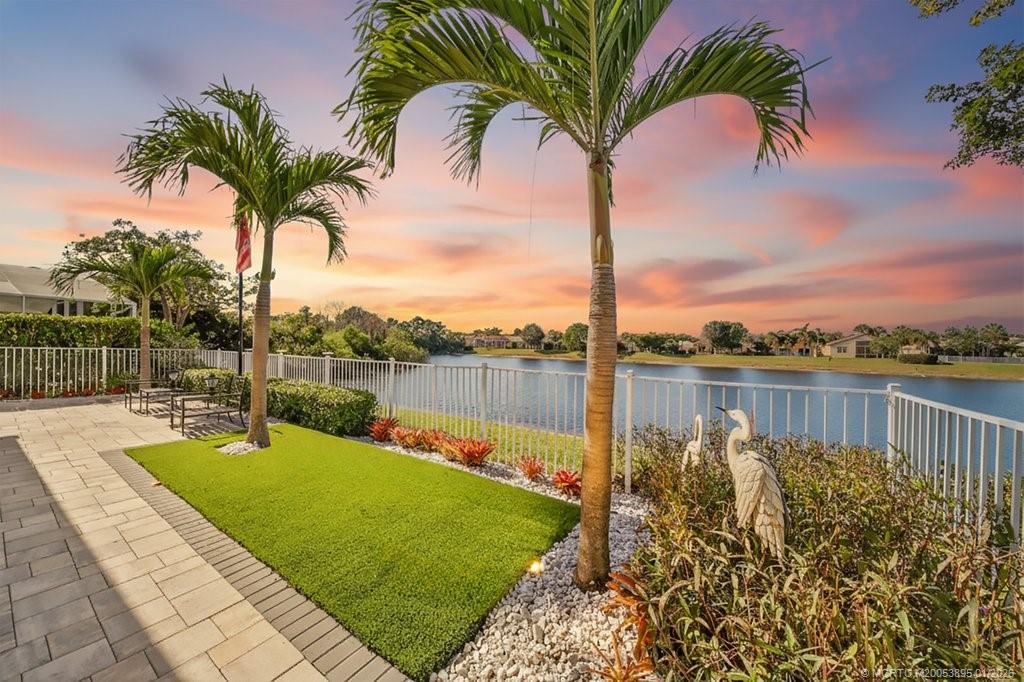 871 Southeast Westminster Place Stuart, FL 34997 - Photo 5 of 38 a view of a lake with a garden