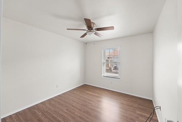 13741 Biggs Street Dallas, TX 75253 - Photo 11 of 17 an empty room with wooden floor ceiling fan and windows