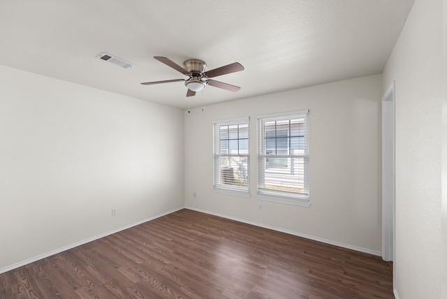 13741 Biggs Street Dallas, TX 75253 - Photo 12 of 17 a view of an empty room with wooden floor and a window