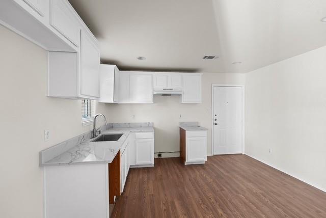 13741 Biggs Street Dallas, TX 75253 - Photo 8 of 17 a kitchen with cabinets wooden floor and stainless steel appliances