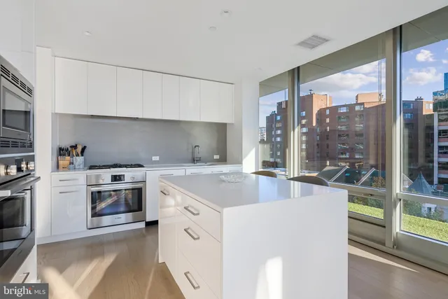 a kitchen with stainless steel appliances granite countertop a stove and a sink