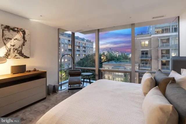 a bedroom with a large bed and a large window