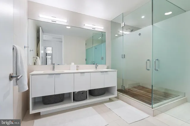 a living room with furniture a bookshelf and a window