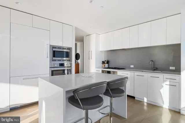 a kitchen with appliances cabinets and wooden floor