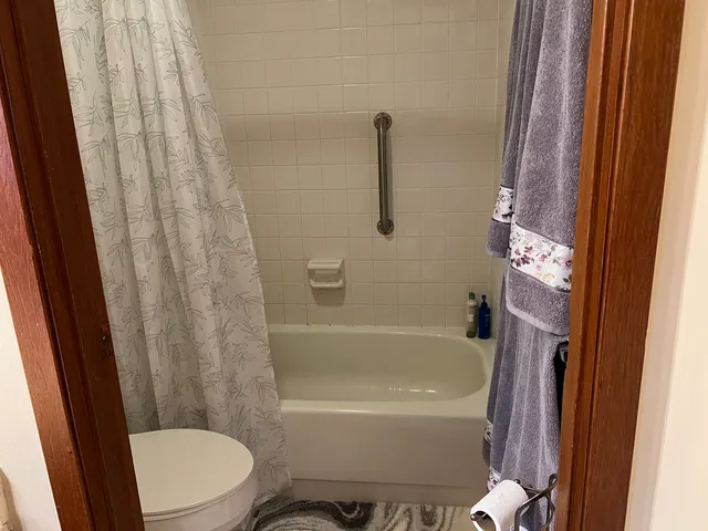 a white bath tub sitting next to a white toilet