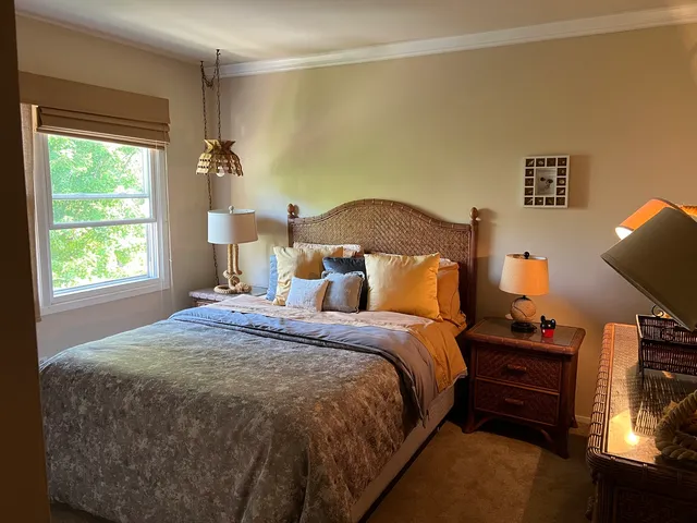 a bedroom with a bed and window