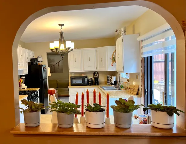 a kitchen with a dining table and chairs