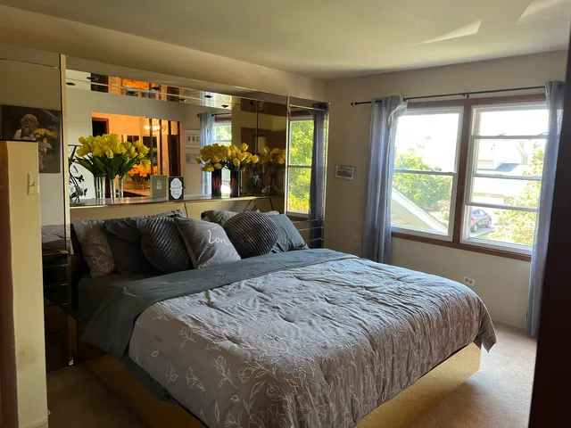 a bed sitting in a bedroom next to a window