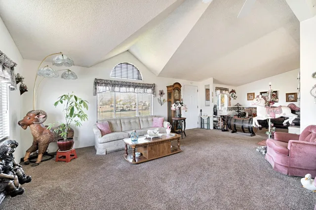 a bedroom with furniture and a large window