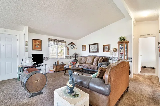 a living room with furniture a fireplace and gym equipment