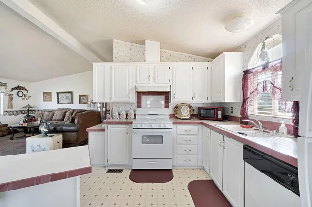 a kitchen with a white cabinets and white appliances