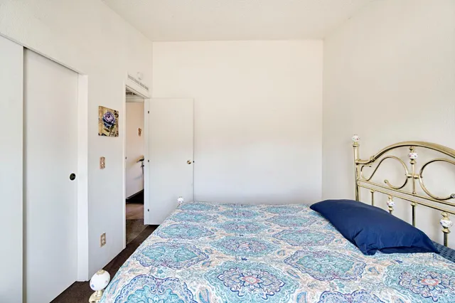 a bedroom with a bed and a dresser