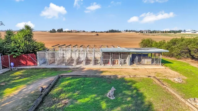 an aerial view of a house with a yard and lake view