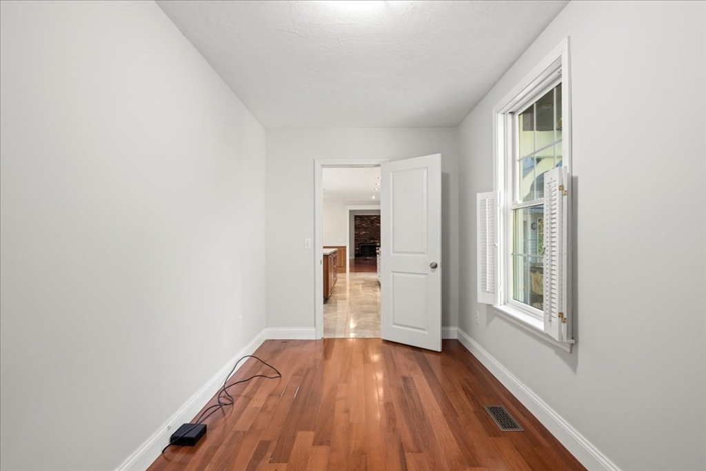 8 Arch Street Shrewsbury, MA 01545 - Photo 16 of 42 a view of a hallway with wooden floor and a window