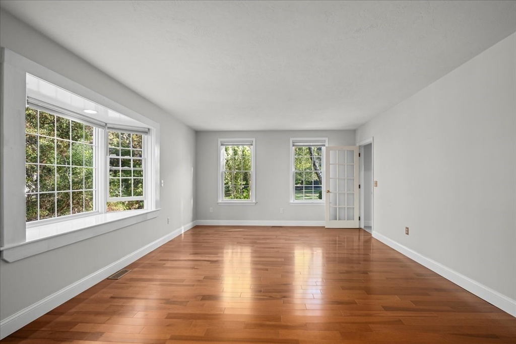 8 Arch Street Shrewsbury, MA 01545 - Photo 18 of 42 a view of empty room with wooden floor and fan