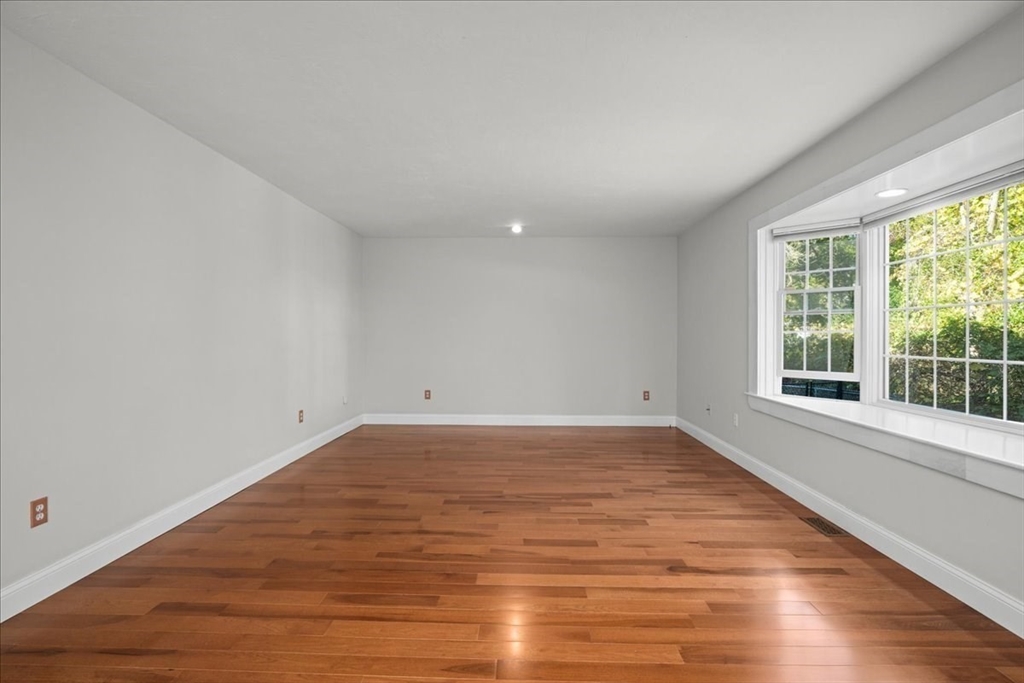 8 Arch Street Shrewsbury, MA 01545 - Photo 19 of 42 a view of empty room with wooden floor and fan