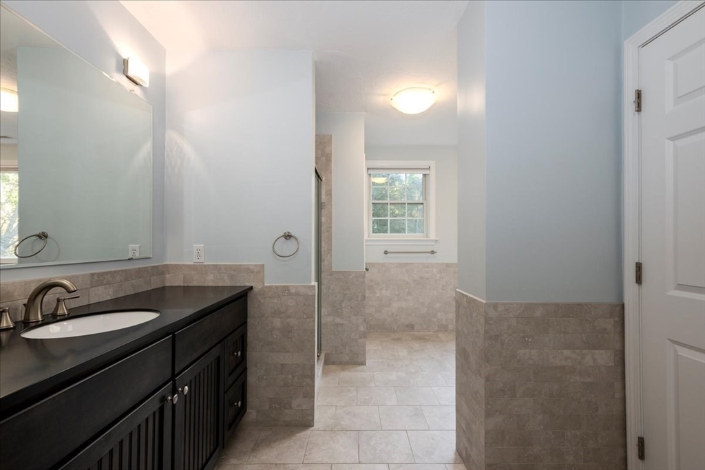 8 Arch Street Shrewsbury, MA 01545 - Photo 24 of 42 a bathroom with a granite countertop sink and a mirror