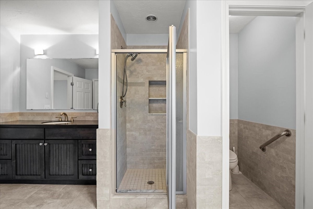 8 Arch Street Shrewsbury, MA 01545 - Photo 25 of 42 a bathroom with a granite countertop sink shower and a mirror