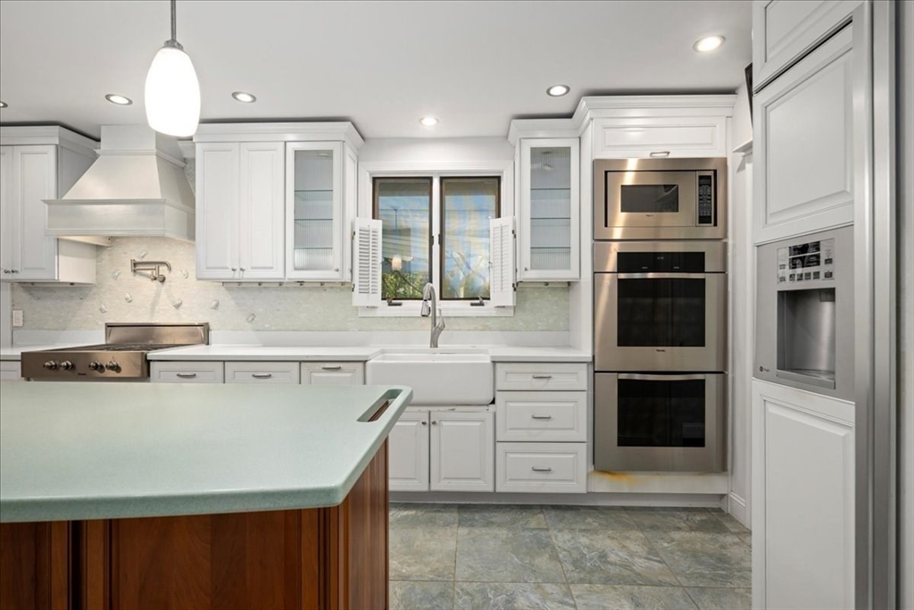 8 Arch Street Shrewsbury, MA 01545 - Photo 6 of 42 a kitchen with stainless steel appliances a stove sink and cabinets
