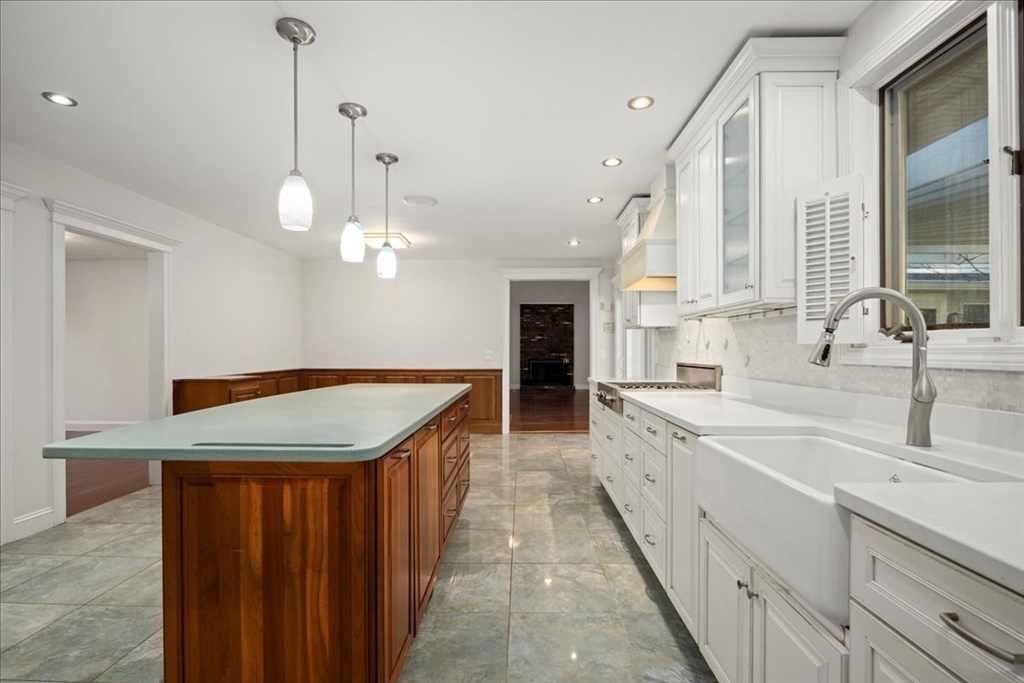 8 Arch Street Shrewsbury, MA 01545 - Photo 7 of 42 a large kitchen with kitchen island a sink stainless steel appliances and a chandelier