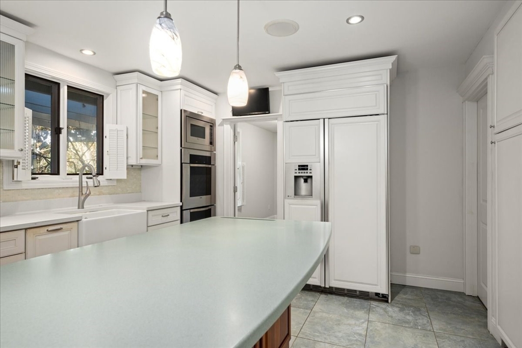 8 Arch Street Shrewsbury, MA 01545 - Photo 8 of 42 a view of a kitchen with a sink and refrigerator