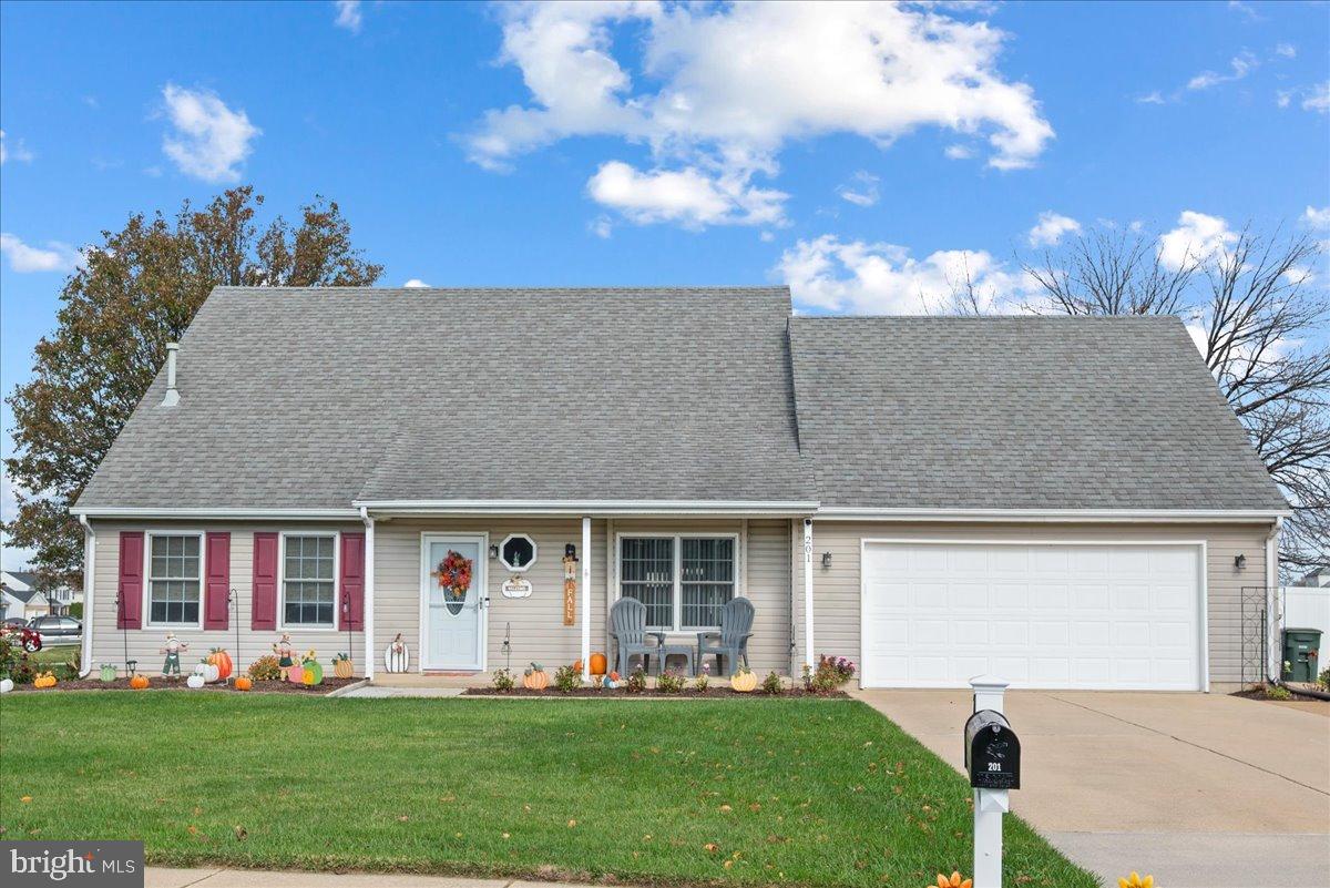 a front view of a house with a yard and porch