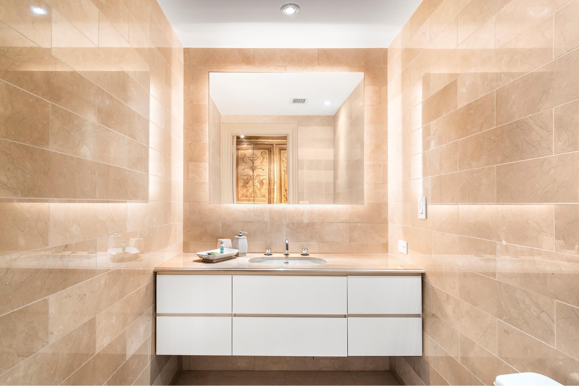 160 Central Park South, Unit 915 Manhattan, NY 10019 - Photo 11 of 18 a bathroom with a sink and a mirror