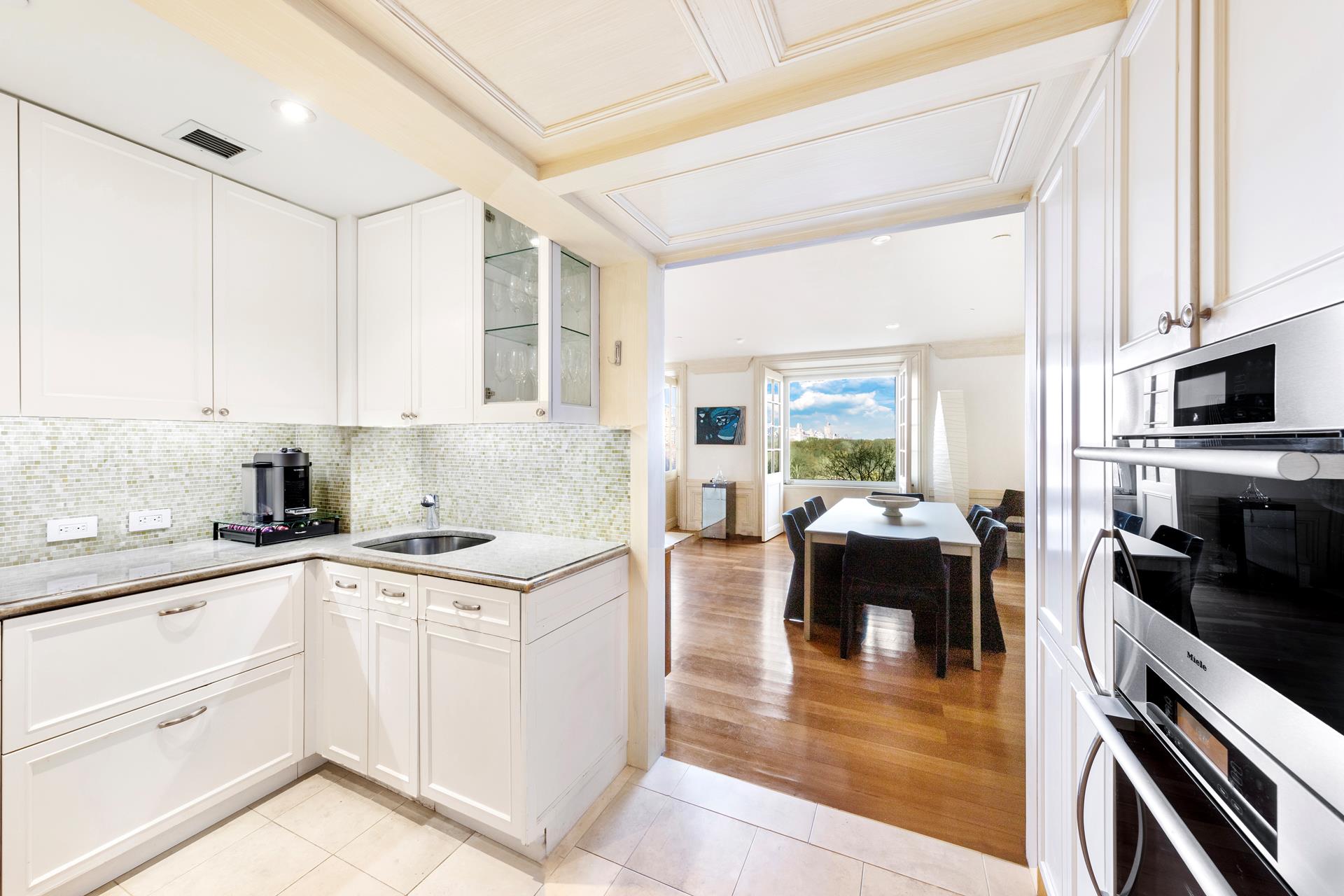 160 Central Park South, Unit 915 Manhattan, NY 10019 - Photo 3 of 18 a kitchen with a sink stove and cabinets