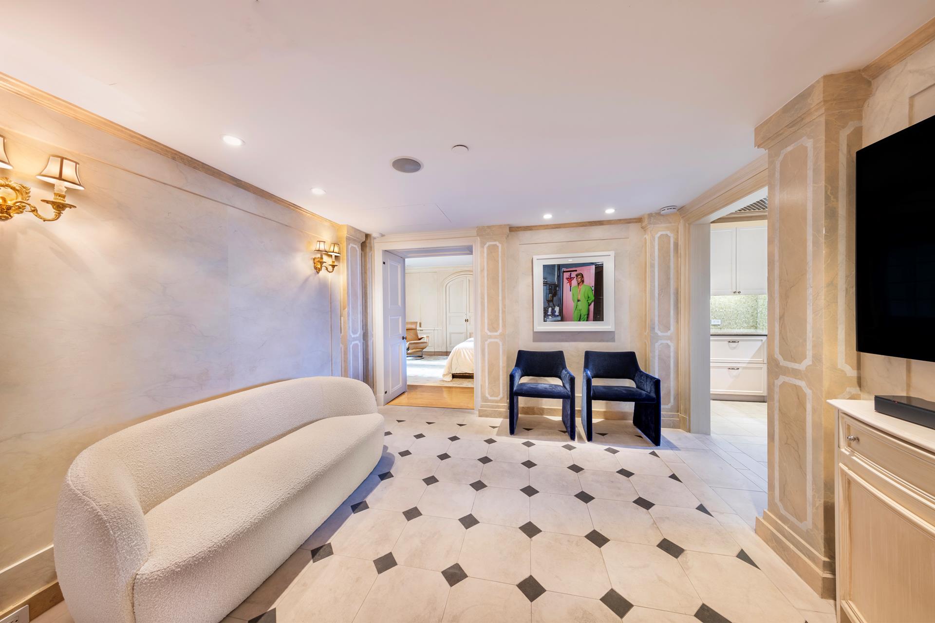 160 Central Park South, Unit 915 Manhattan, NY 10019 - Photo 4 of 18 a bedroom with a bed and a television